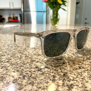 Men’s Prada Sunglasses. Clear frames with blue lenses.